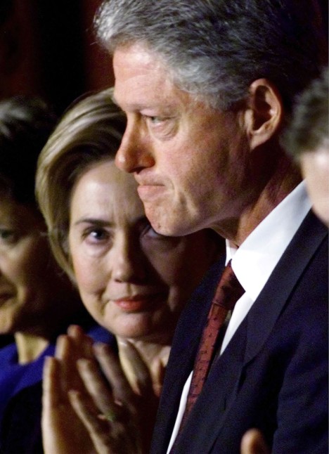 Former U.S. first lady Hillary Clinton (L) looks at her husband, President Bill Clinton, immediately following his address to the National Prayer Breakfast in Washington DC in this February 4, 1999 file photo. U.S. Senator Hillary Clinton (D-NY) in her soon to be published book "Living History," said that when Bill Clinton told her of the relationship with Monica Lewinsky, "I could hardly breathe. Gulping for air, I started crying and yelling at him."    REUTERS/Win McNamee/File